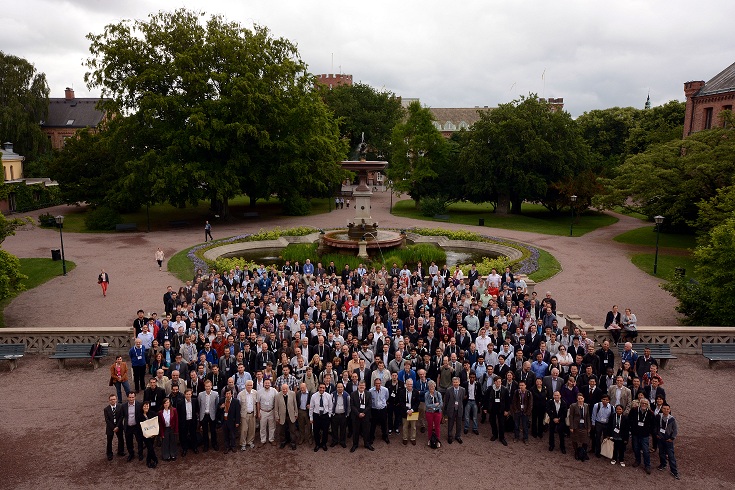 Large group of people in front of a fountain, image.